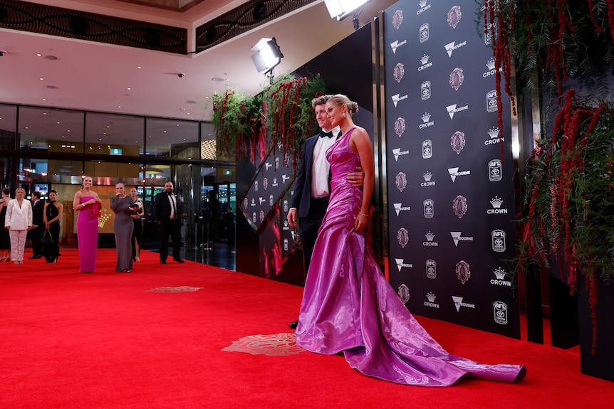 Chad Warner and his partner Alice Hughes pose for a photo on the Brownlow red carpet