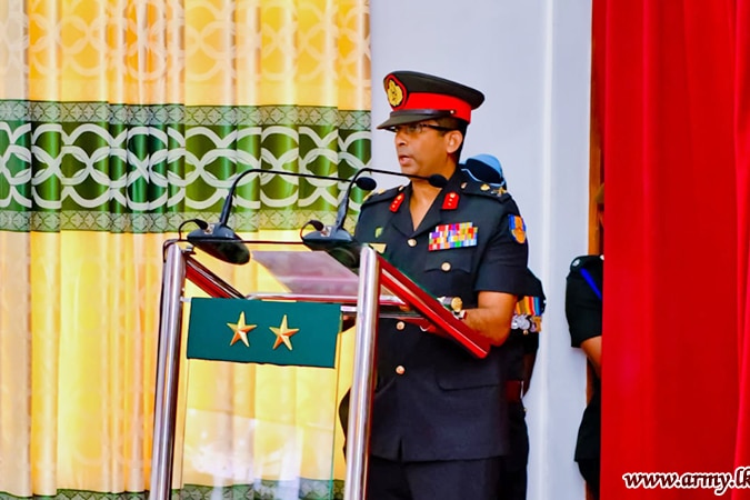 A man in military uniform speaks into microphones at a lectern.