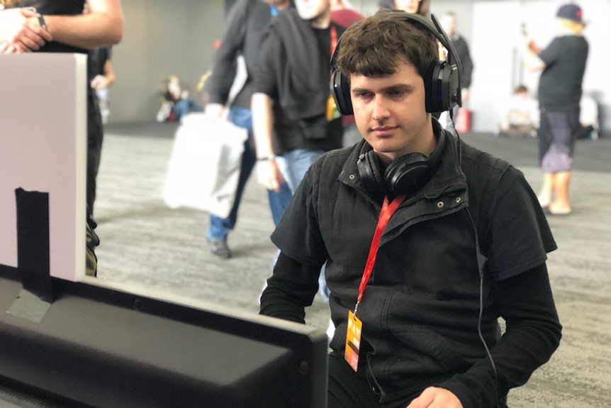 Autistic game developer Bradley Hennessey plays his game 'An Aspie Life' at PAX AUS 2018