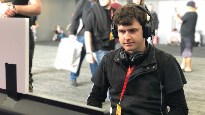 Autistic game developer Bradley Hennessey plays his game 'An Aspie Life' at PAX AUS 2018