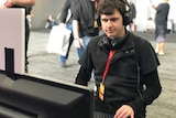 Autistic game developer Bradley Hennessey plays his game 'An Aspie Life' at PAX AUS 2018