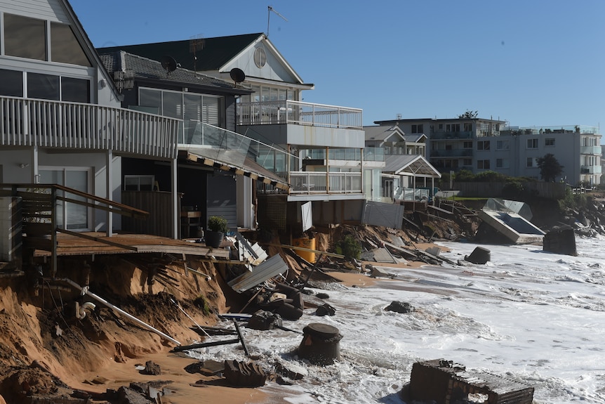 destroyed beachfront houses after a massive swell