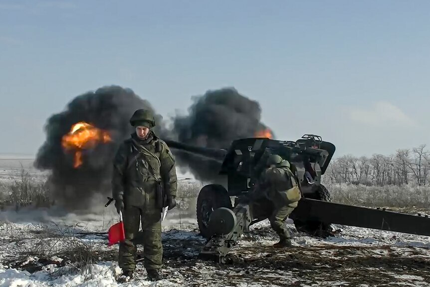 Russian troops fire a howitzer.