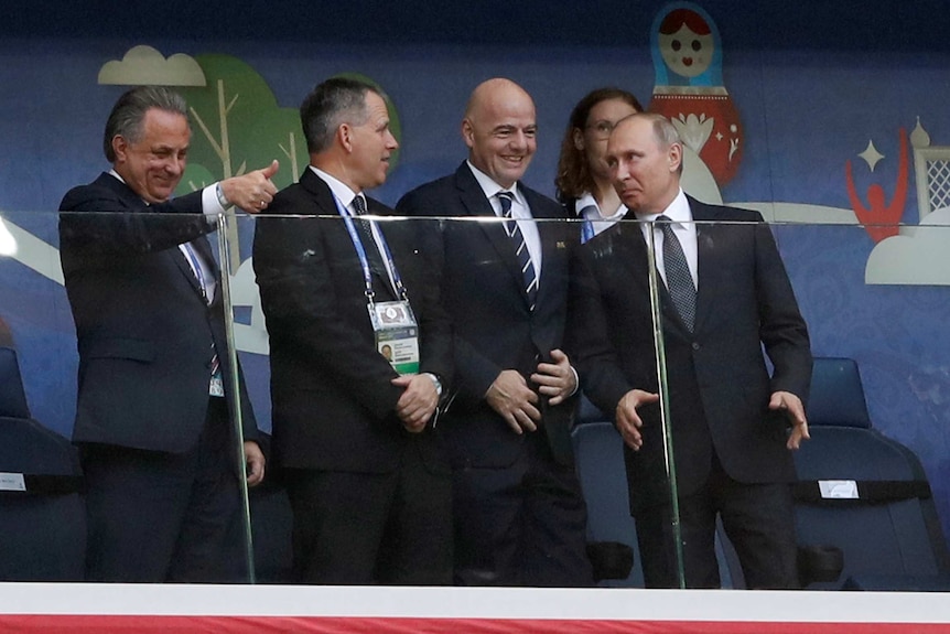 Russia President Vladimir Putin (R) stands next to FIFA president Gianni Infantino in the grandstand in St Petersburg.
