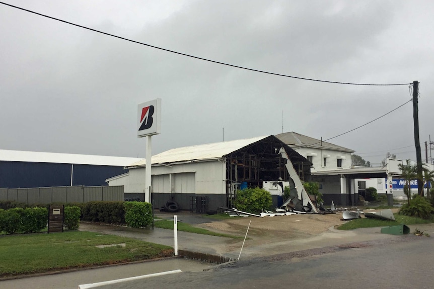 The facade of a tyre shop in Bowen is badly damaged.