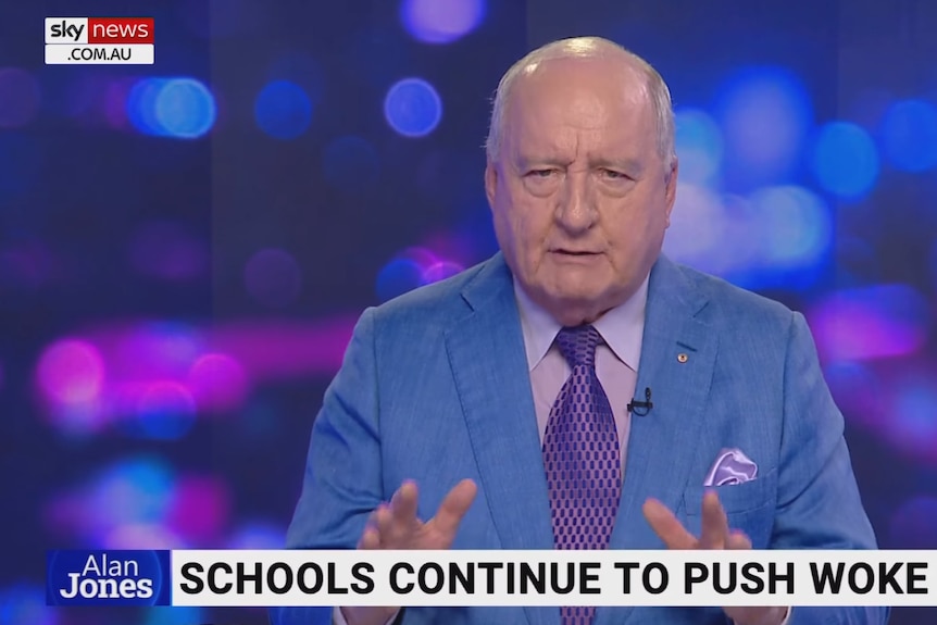 screenshot of Alan Jones wearing blue shirt and purple tie in a tv studio with Sky News graphics