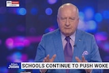 screenshot of Alan Jones wearing blue shirt and purple tie in a tv studio with Sky News graphics
