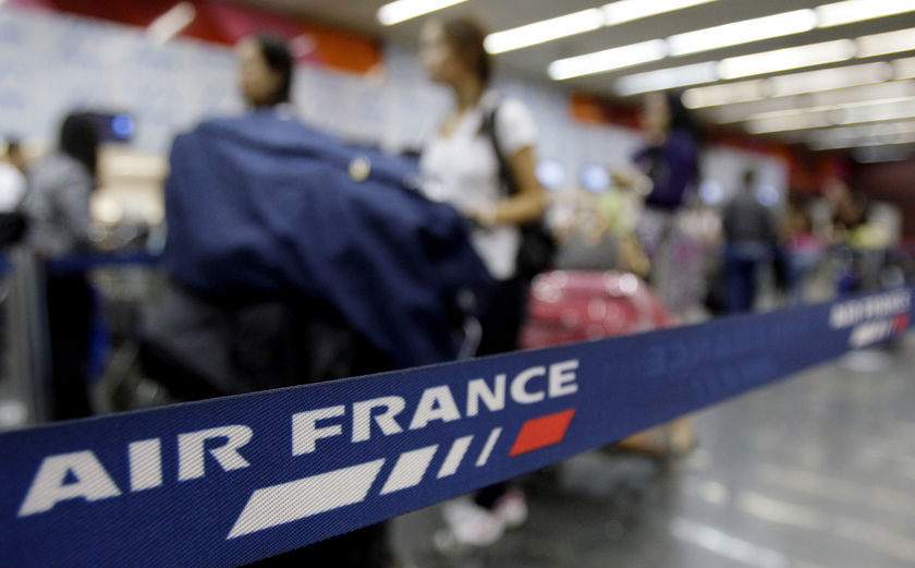 Passengers wait at the Air France check-in counter