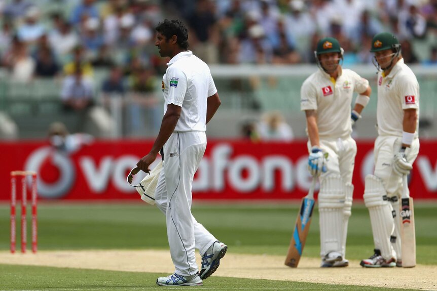 Injury worry ... Sri Lanka's Chanaka Welegedara limps off as Michael Clarke and Shane Watson look on.