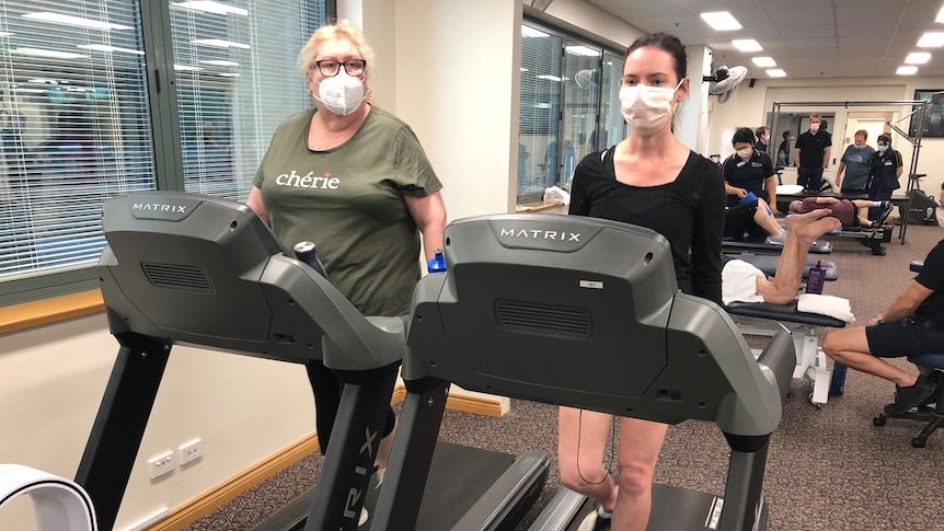 Two women on treadmills.