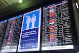 Airport information sign featuring delayed flights