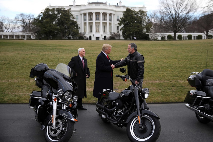 US President Donald Trump shakes hands with Matthew S Levatich, CEO of Harley Davidson.