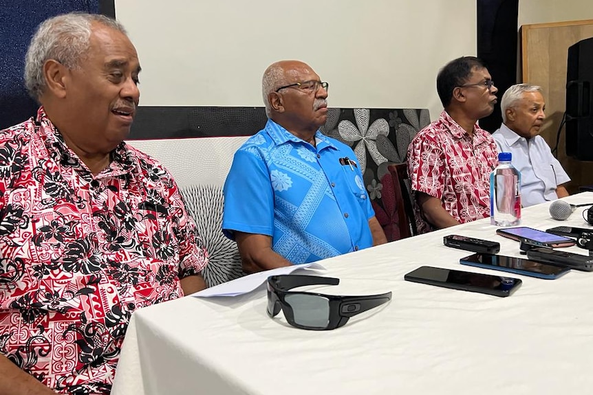 A table of four Fijian opposition leaders who are making an address
