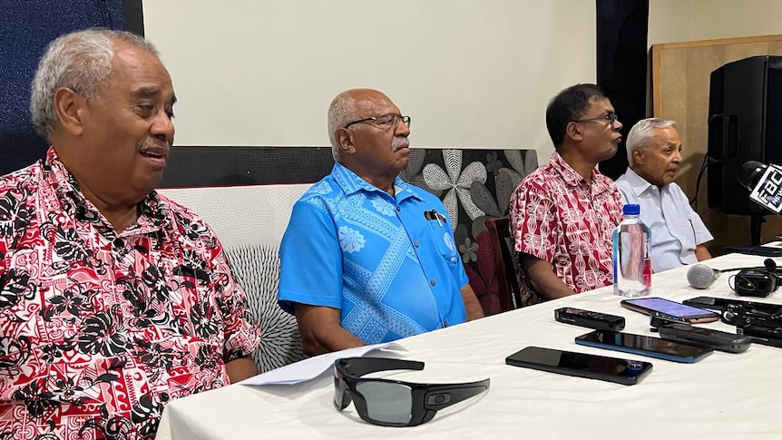 A table of four Fijian opposition leaders who are making an address