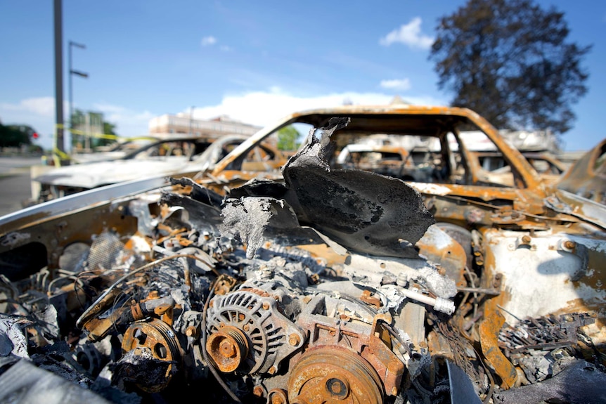 A close up shot of a burned hood of a car