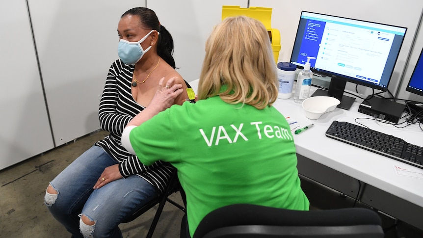 A woman receives her COVID vaccination in Brisbane