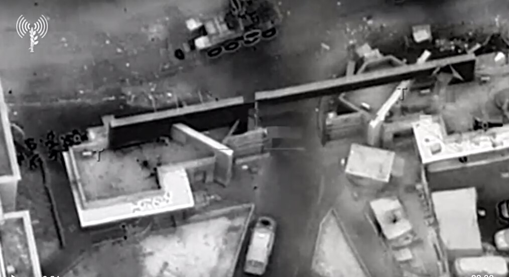 Grainy black and white photo showing a view looking down onto a building.