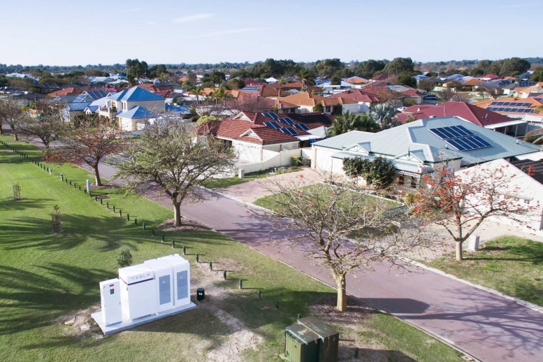 Aerial shot of a community battery in parkland near a suburb