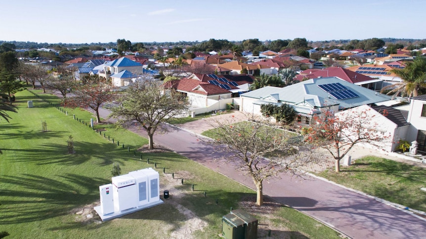 Aerial shot of a community battery in parkland near a suburb