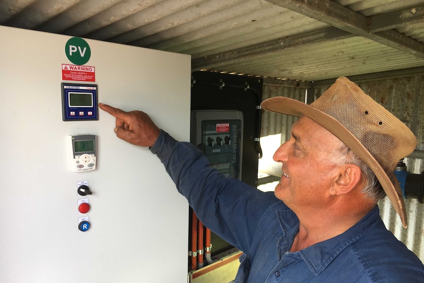 John Russo measures the solar energy powering his water pump.