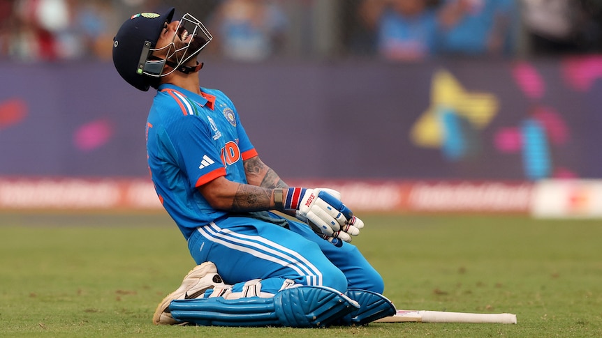 Virat Kohli leans back on his knees