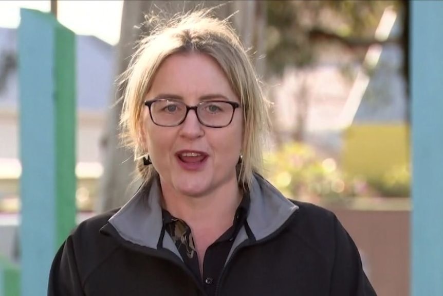 Transport Infrastructure Minister Jacinta Allan, a woman with blonde hair and glasses, speaks on a sunny day.