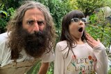 Image of a bearded Costa, from Gardening Australia, and a young girl with glasses, pulling faces together in the garden.