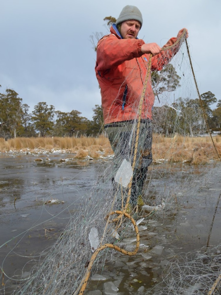 Chris Boon braves the cold to check nets at Lake Sorell.