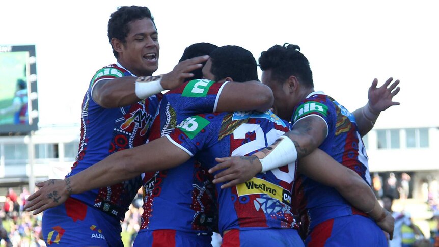 Knights celebrate try against the Warriors