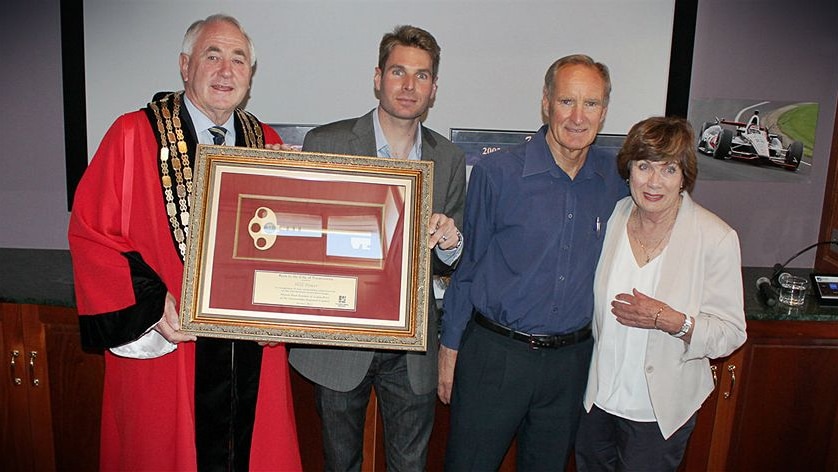 Mayor in riobe holds frame key to city with Will Power and his parents Bob and Margaret Power