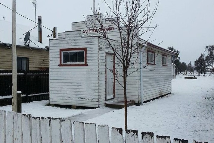 a small hall surrounded by snow