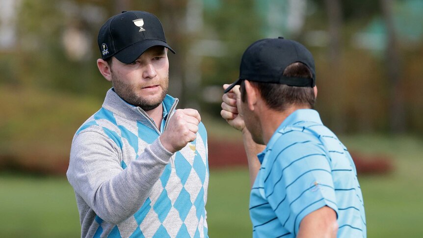 Branden grace fist bumps during Presidents Cup