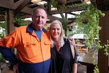 Rick Shelley and Nikki Phillips stand next to each other looking at the camera.