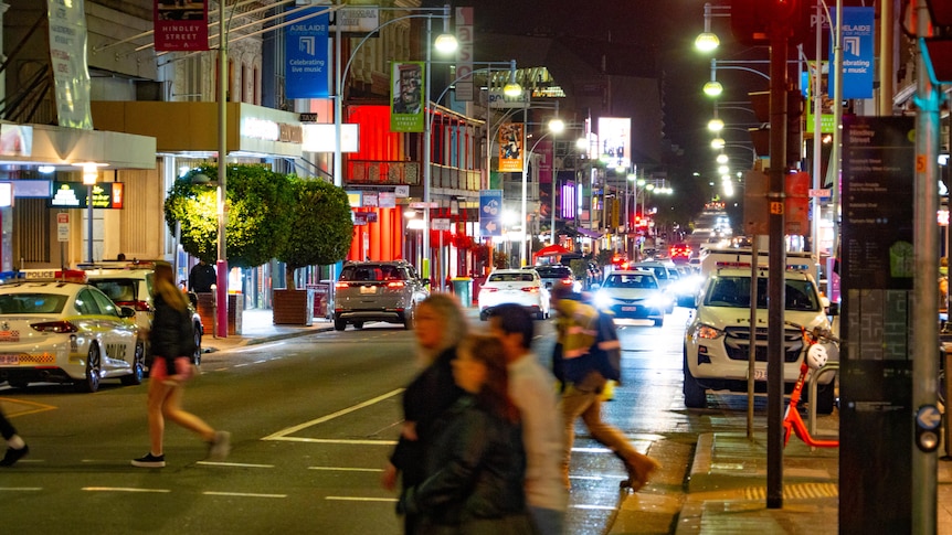 People cross a city street.