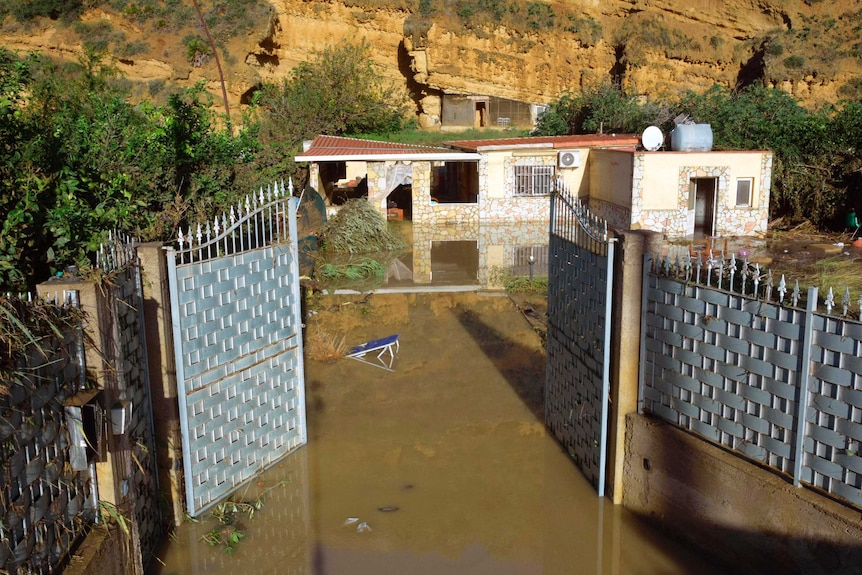 A view of the flooded house where nine people lost their lives near Palermo. The front of the house is complete flooded.
