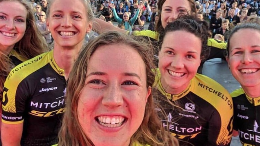 Six smiling women cyclists.