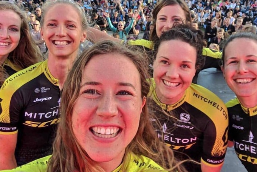 Six smiling women cyclists.