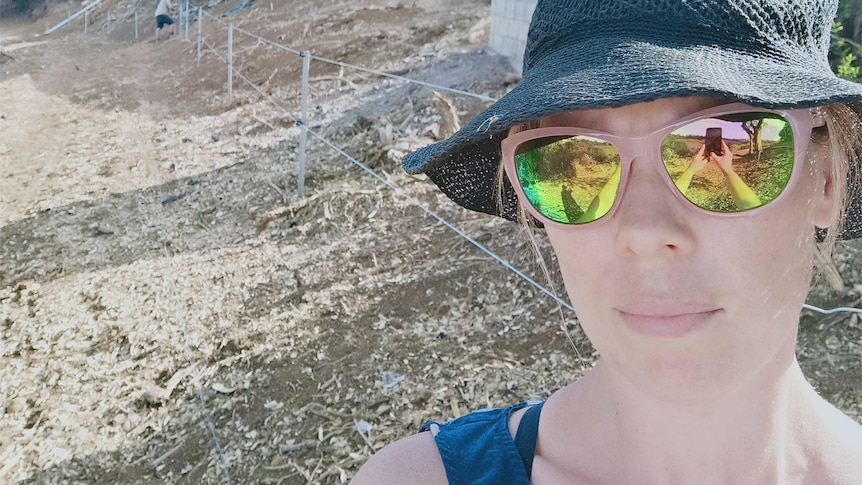 Cassie Andrew stands in front of a chicken shed.