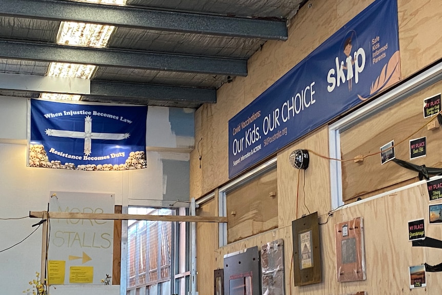 Flags and signs on a wall.