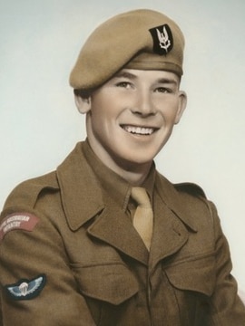 A man wearing a beret poses for a military portrait.