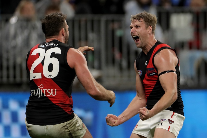 Jake Stringer yells in the face of Essendon Bombers teammate Cale Hooker during an AFL win over West Coast Eagles.