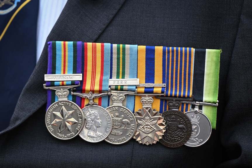 Photos of Australian Navy medals worn on someone, with the ribbons being a number of colours