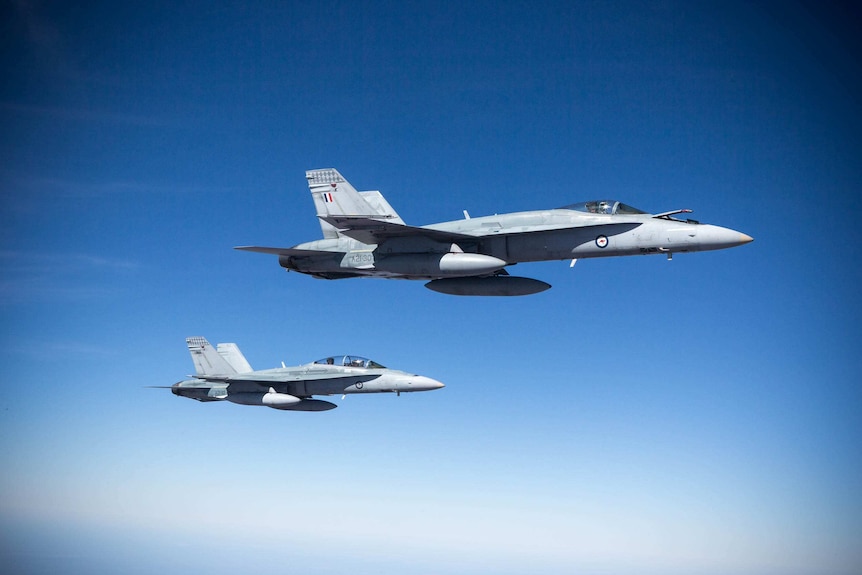 Two RAAF F/A-18A Hornets in close formation during Exercise Pitch Black over northern Australia in August 2014.