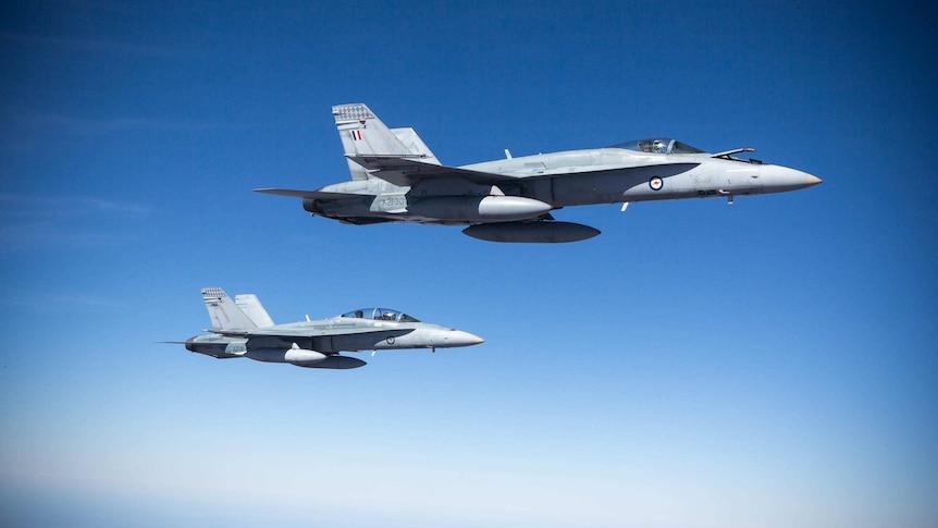 Two RAAF F/A-18A Hornets in close formation during Exercise Pitch Black over northern Australia in August 2014.