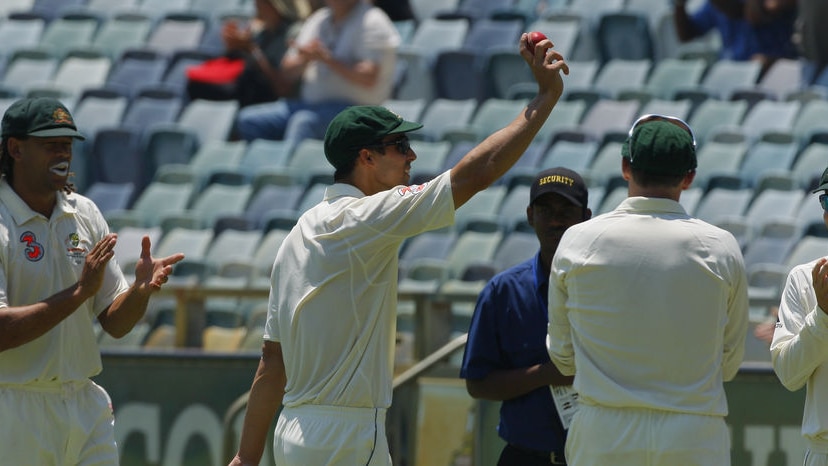 Mitchell Johnson holds the ball aloft after taking 8 for 61