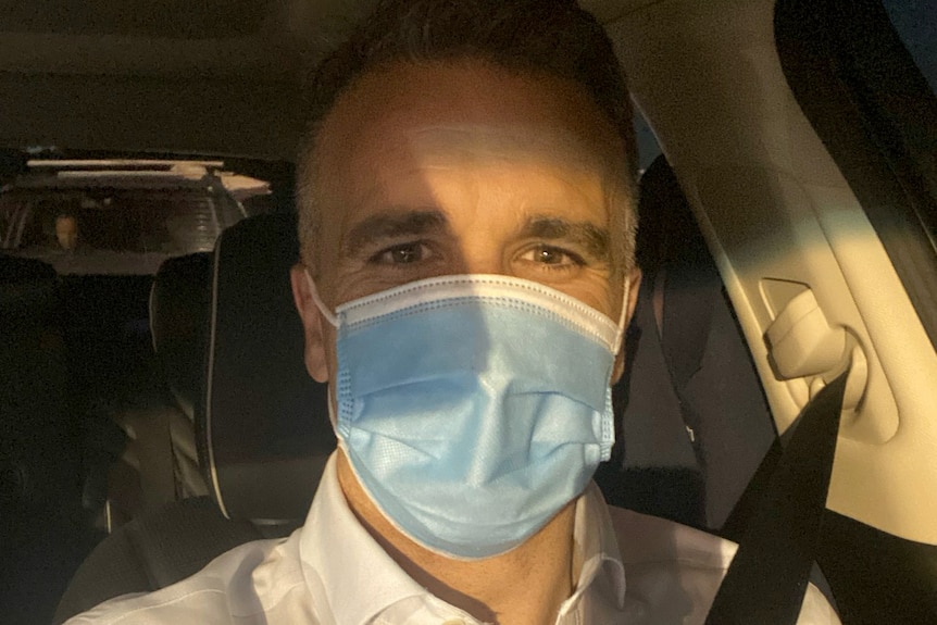 Salvation Army opposition leader Peter Malinauskas wears a surgical mask.