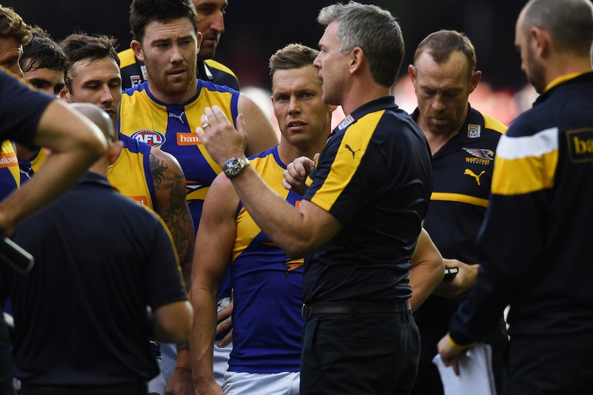 Sam Mitchell and his West Coast Eagles teammates listen to coach Adam Simpson in a team huddle at Docklands Stadium.