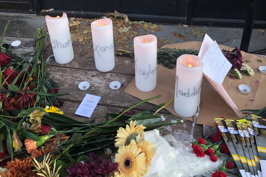 Four candles surrounded by flowers 