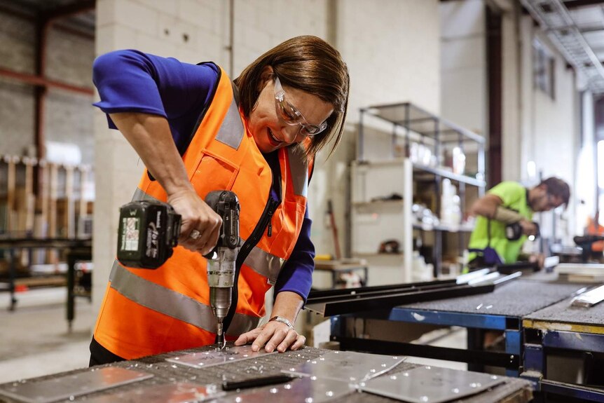 LNP leader Deb Frecklington at a glass factory