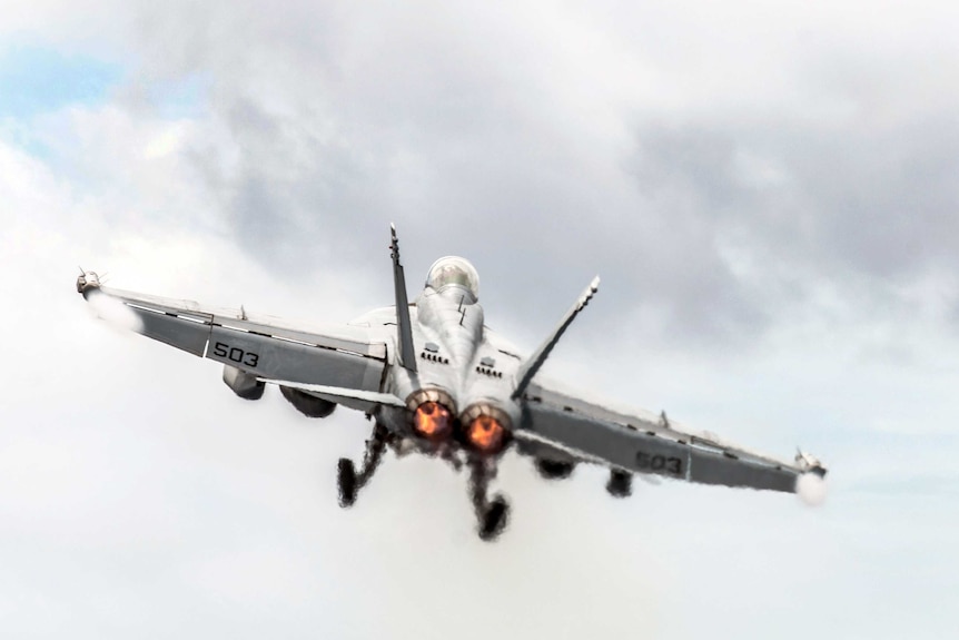 An E/A-18G Growler launches from the flight deck of the USS Ronald Reagan.